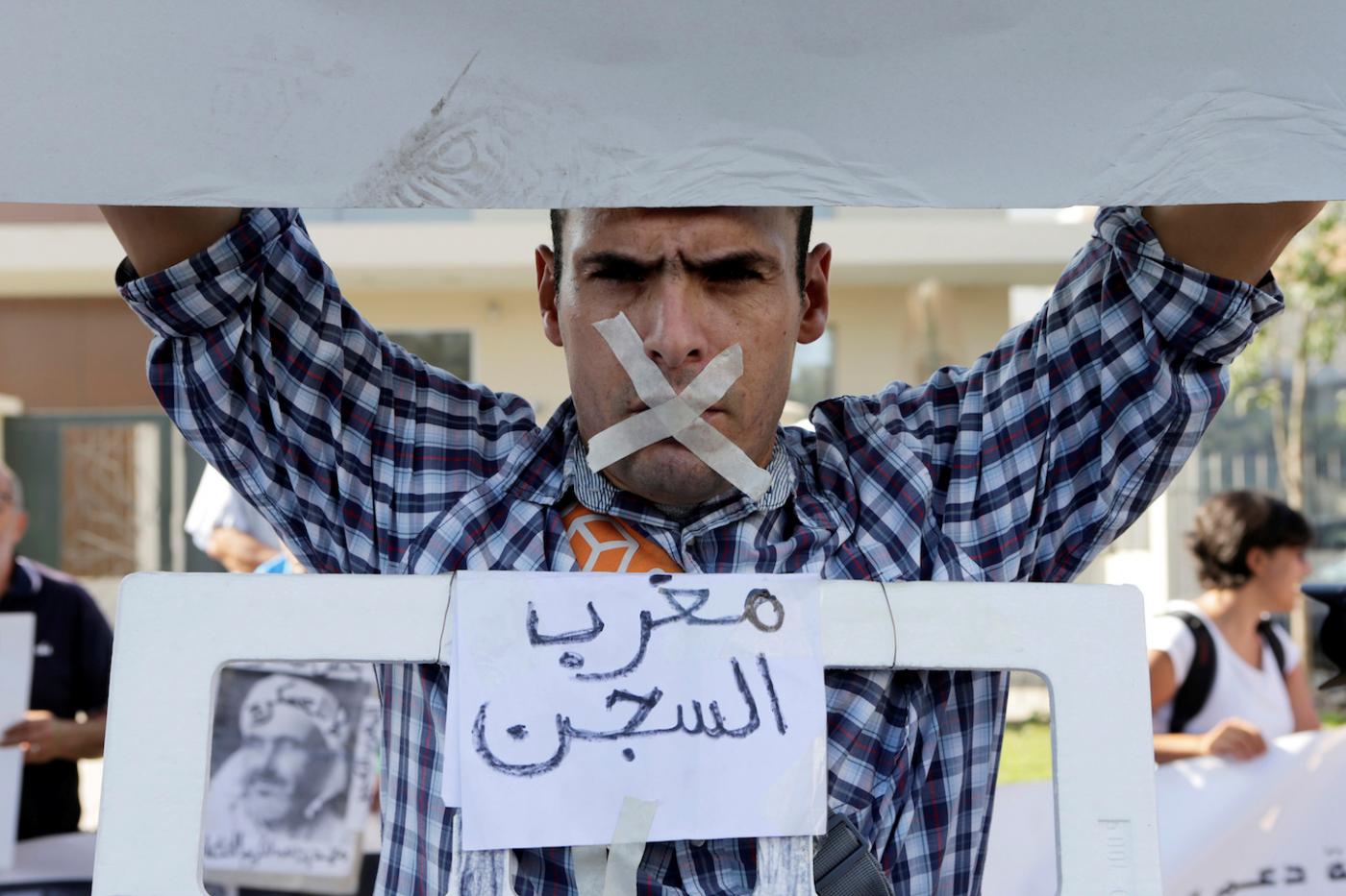 A Hirak activist’s poster reads ‘Moroccan prison’ in Casablanca in 2017 (Reuters)