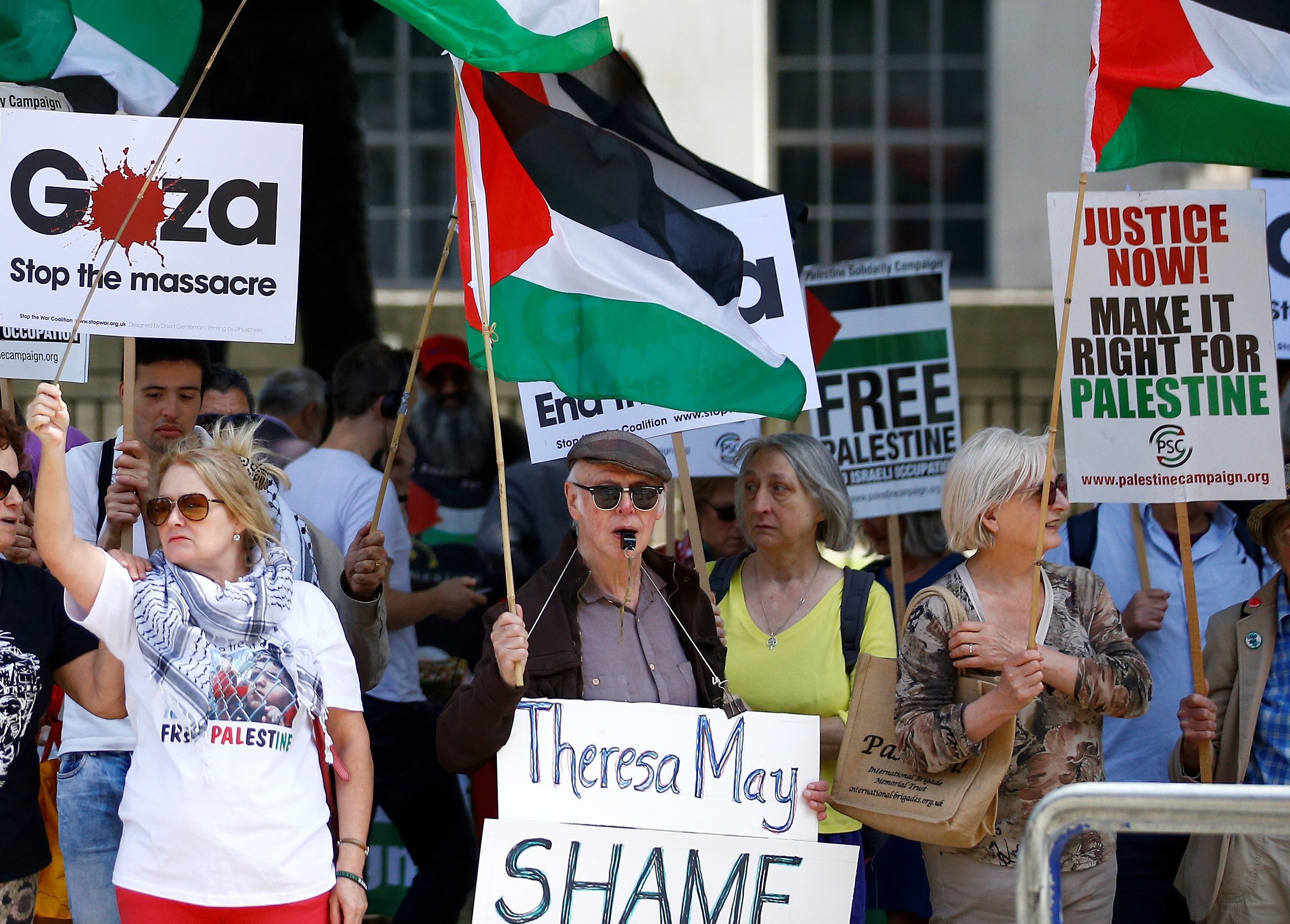  Demonstrators wave Palestinian flags opposite Downing street ahead of the visit by Israel's Prime Minister Benjamin Netanyahu, in London, Britain, on 6 June (Reuters)
