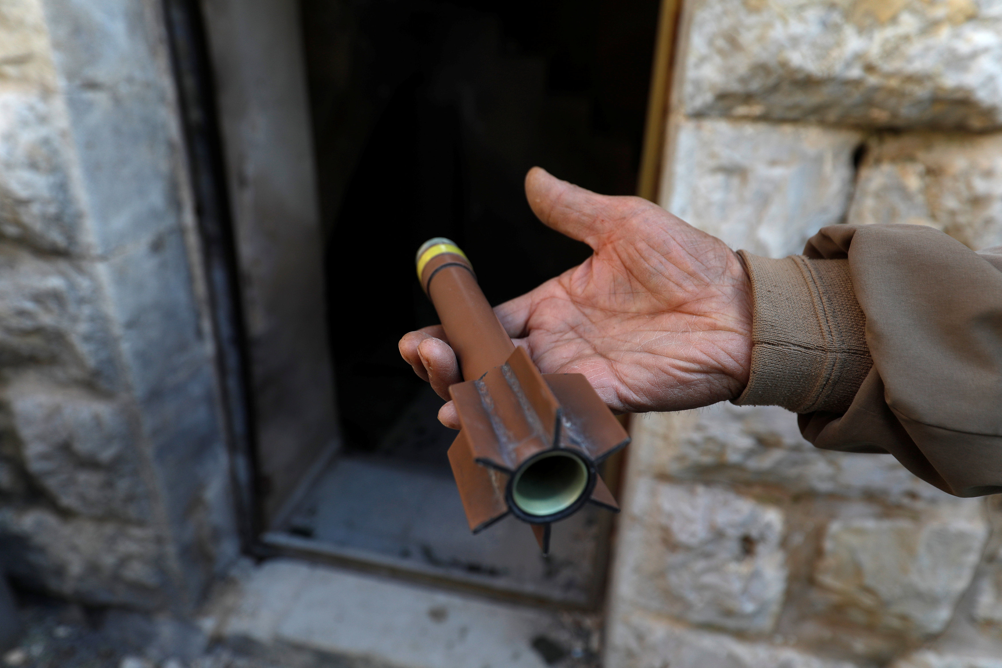 A man shows ammunition outside a house where a Palestinian was killed by Israeli forces, in Abwein village, in the Israeli-occupied West Bank (Reuters)