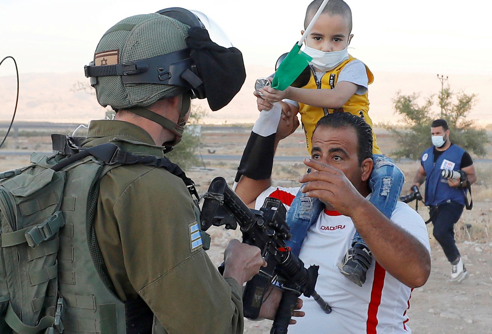 A Palestinian man argues with an Israeli soldier during a protest against Israel's plan to annex parts of the occupied West Bank, in Jordan Valley June 24, 2020