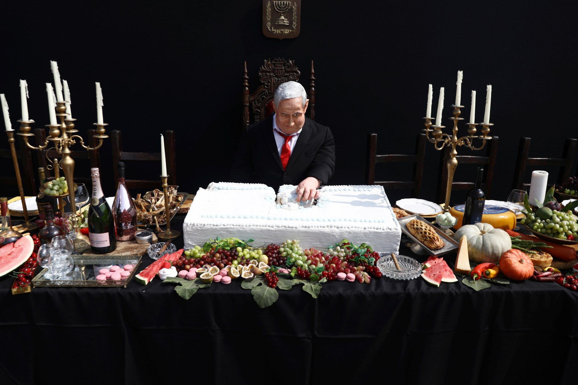 An artwork by Israeli artist Itay Zalait, that includes a sculpture of Israeli Prime Minister Benjamin Netanyahu sitting at a table recalling the famous "Last Supper" (Reuters)