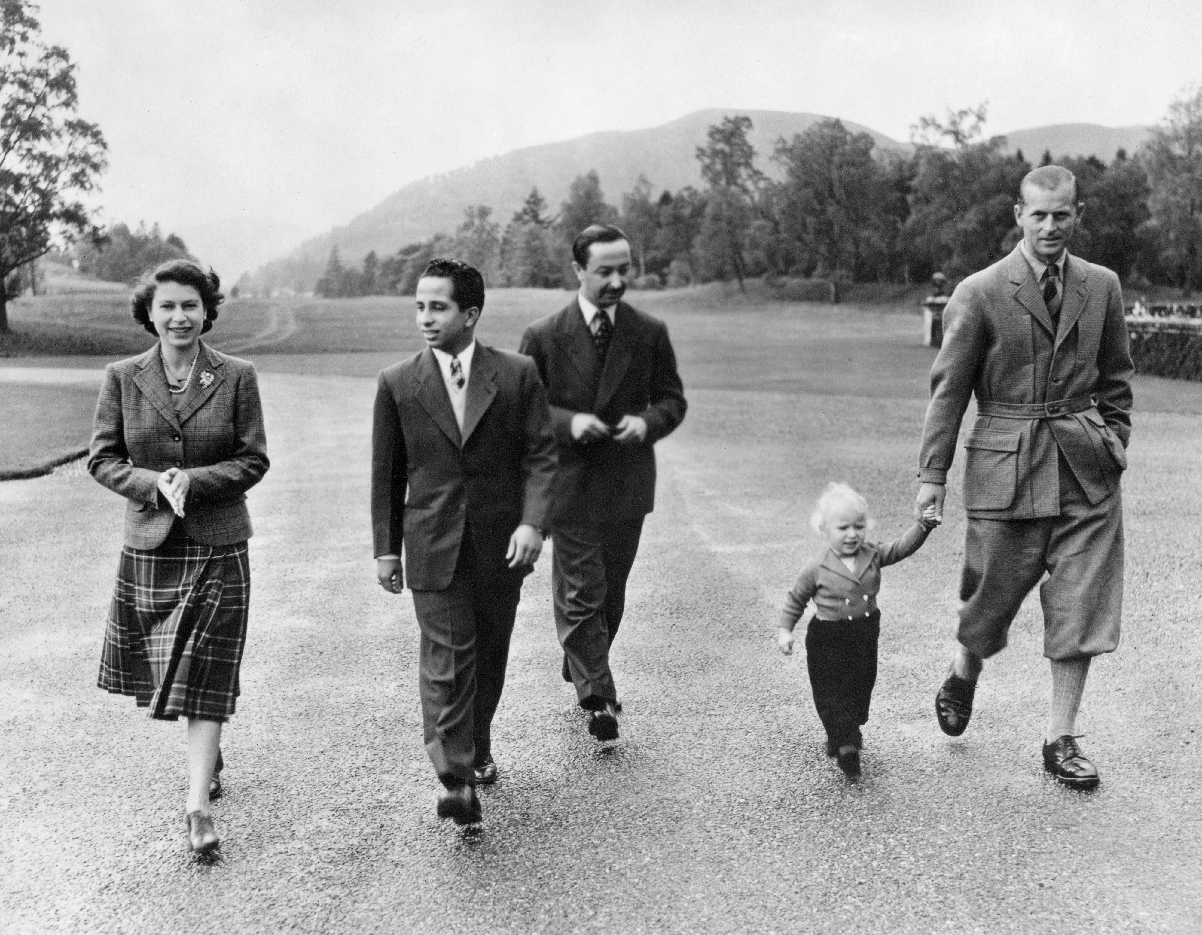 Une photo prise en septembre 1952 dans le parc du château de Balmoral montre (de gauche à droite) la reine Elizabeth II marchant aux côtés de Fayçal II, roi d’Irak, la princesse Anne et le prince Philip (AFP)