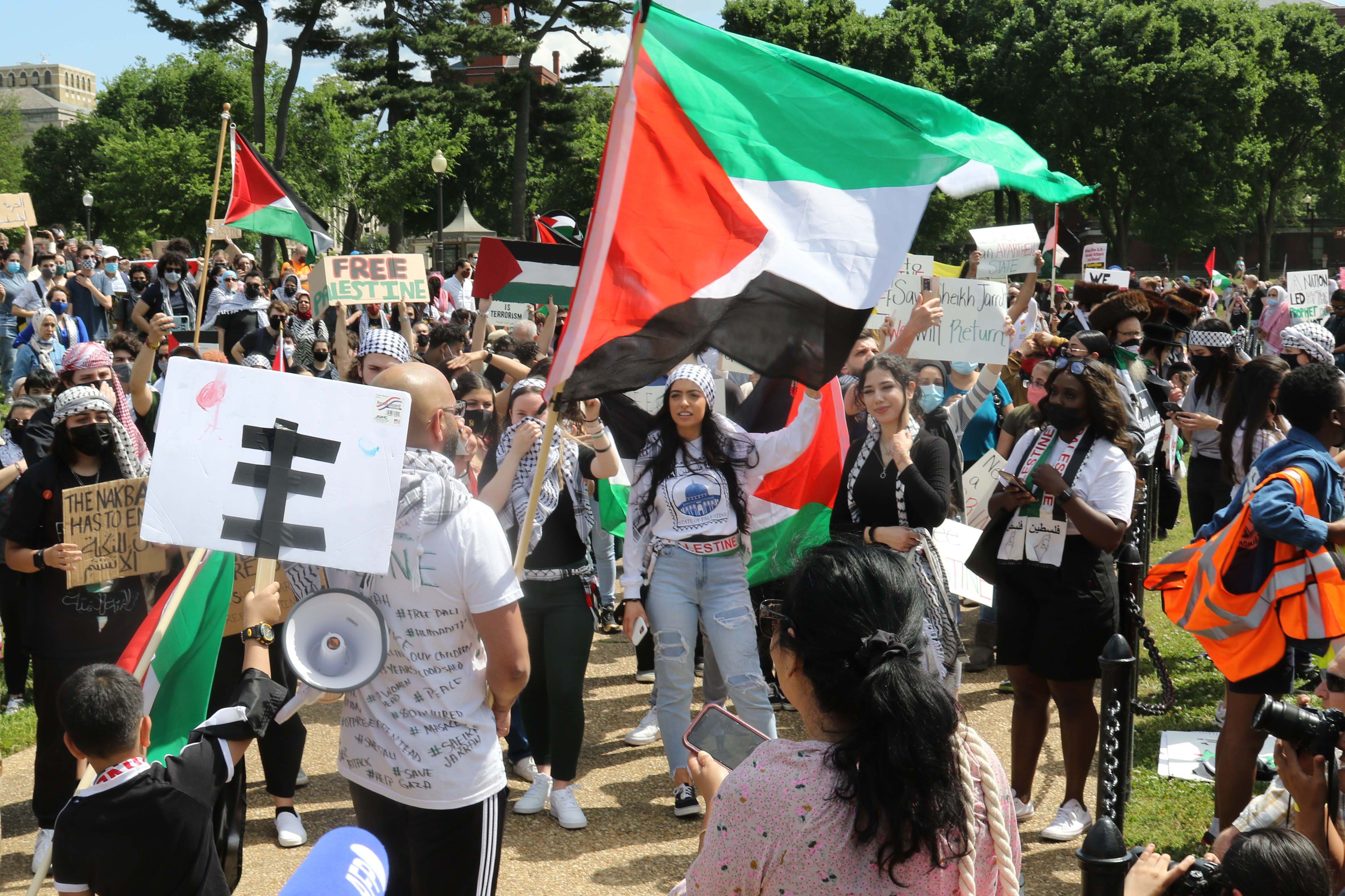 A protester rallies the crowd with chants calling for "Free Palestine" and an end to the Israeli occupation of Palestinian territories.