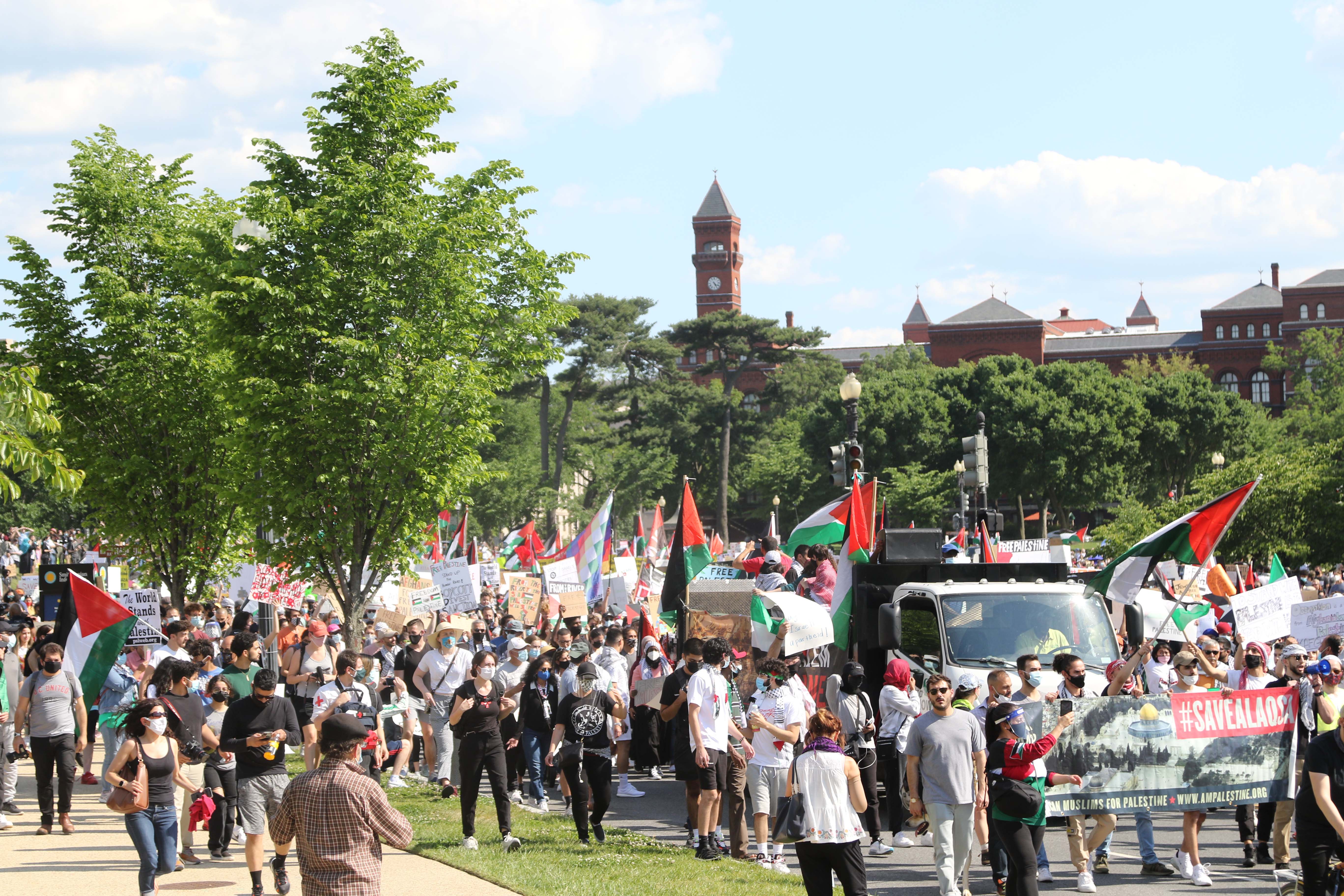 Demonstrators march in the street in downtown Washington DC, near the Washington Monument, on 15 May 2021.