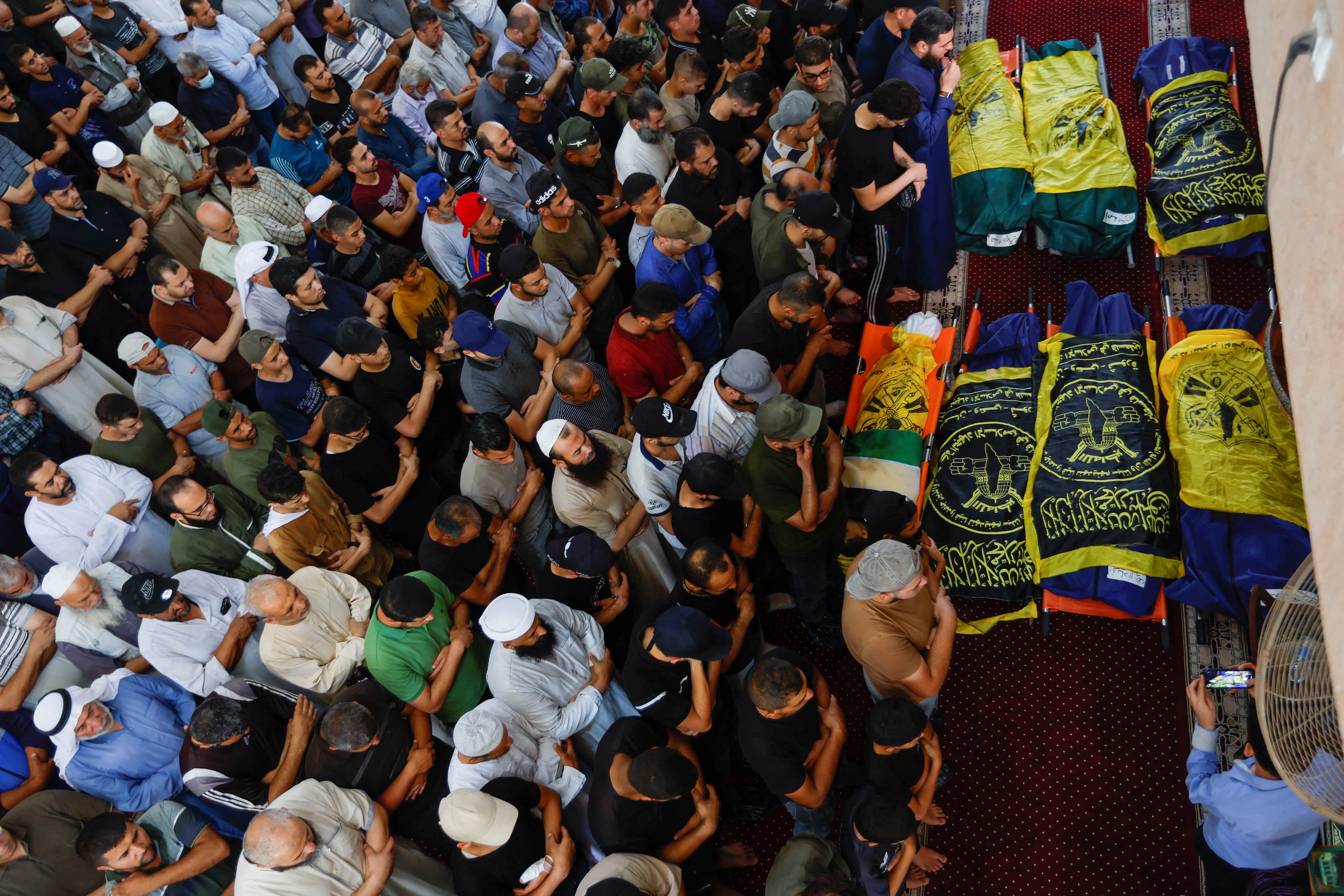 Mourners pray during the funeral of Islamic Jihad commander Khaled Mansour and other Palestinians, who were killed in Israeli air strikes in Rafah in the southern Gaza Strip on 6 August 2022 (Rueters)