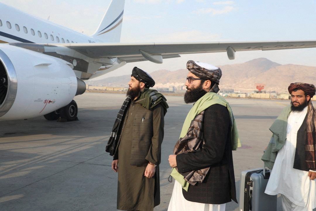 Mawlawi Mohammad Yaqoob Mujahid is seen on the airport tarmac as part of a government delegation leaving for the United Arab Emirates, in Kabul (Reuters)