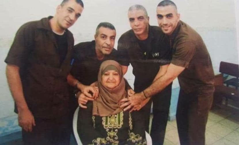 Latifa pictured with four of her sons  in Israeli prisons. (Facebook/Palestinian Prisoners Society)