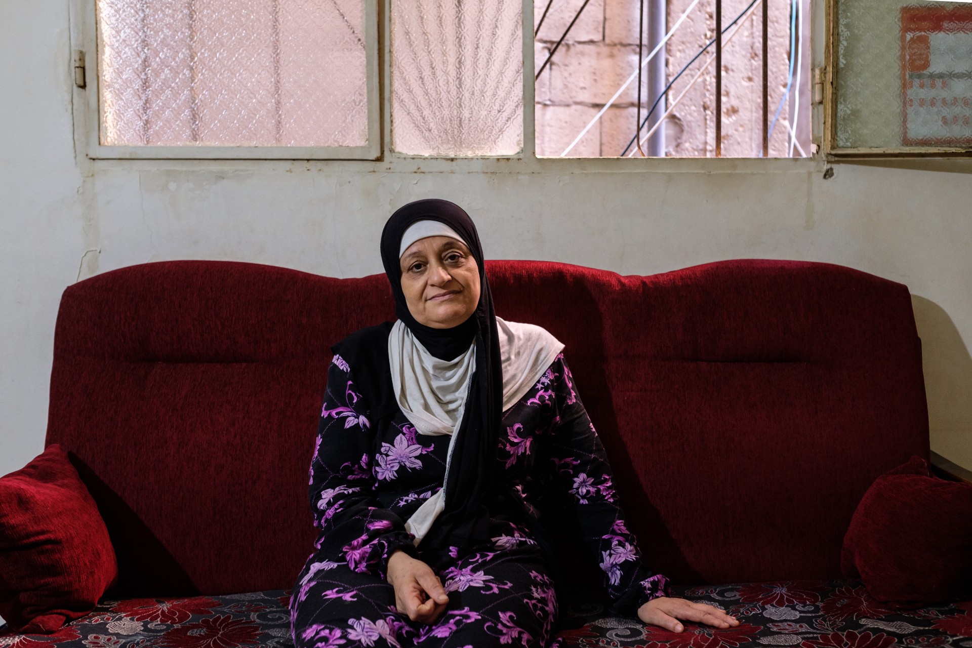 Rajaa Issa Ismael at her home in Shatila. She holds workshops for women's rights and raises awareness against violence (MEE/Rita Kabalan)