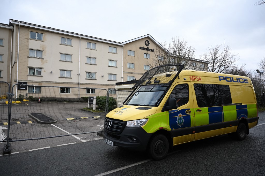 A police van is seen parked outside the closed gates of the Suites Hotel in Knowsley, near Liverpool in north-west England on 11 February 2023 (AFP)