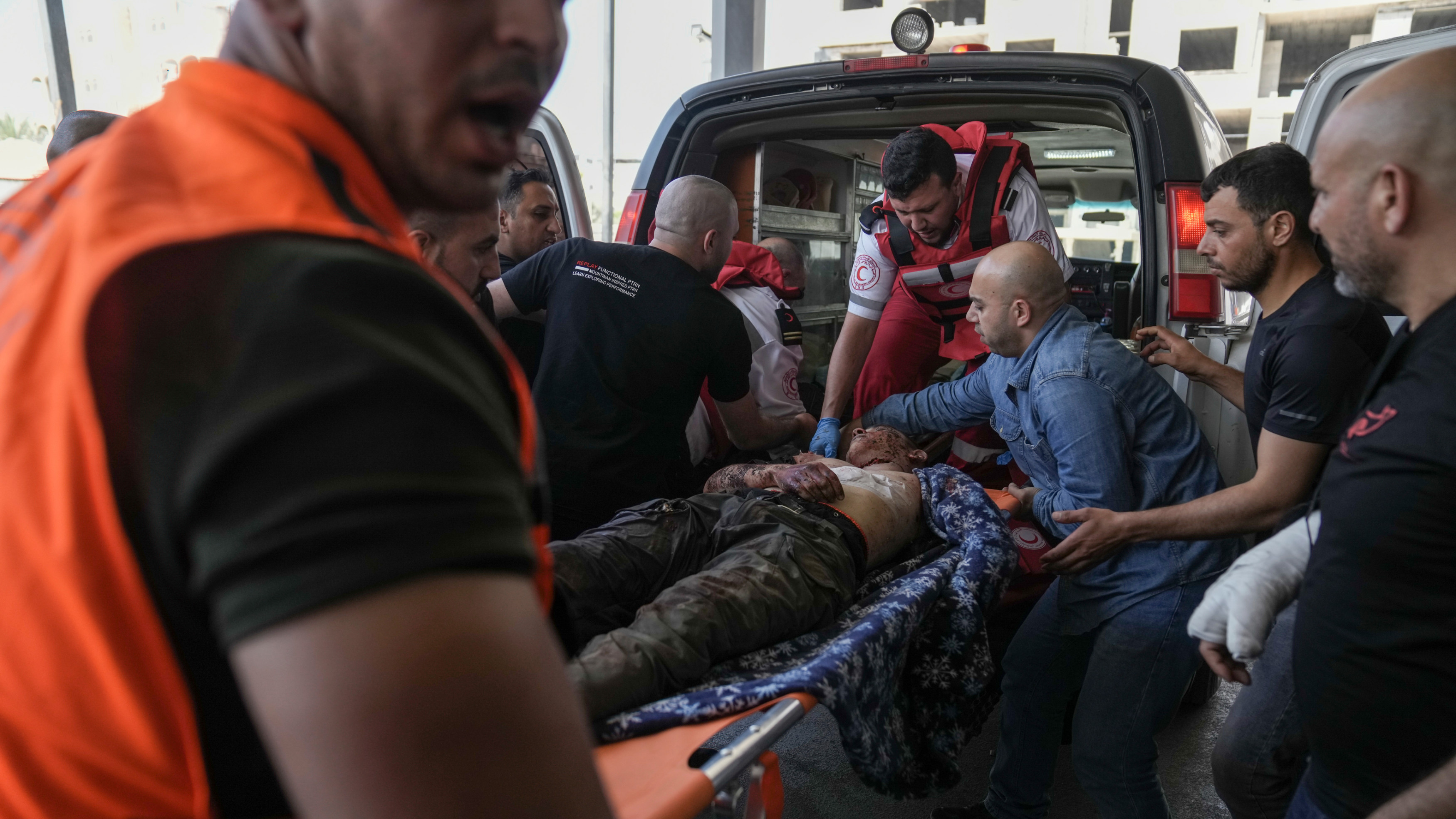 A wounded Palestinian is carried into a hospital during an Israeli military offensive in the Jenin refugee camp on 3 July 2023 (AP)