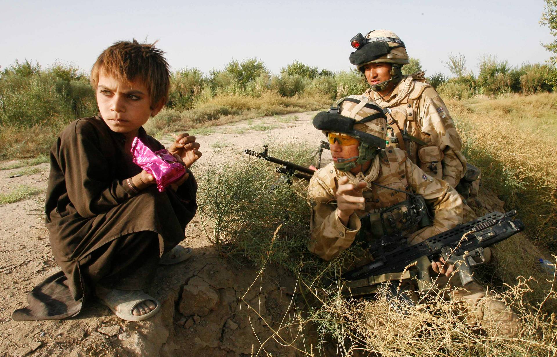 Esmat Mohammed, seven, with British Army Ghurka soldiers in Helmand province in September 2007 (Peter Nicholls/The Times)