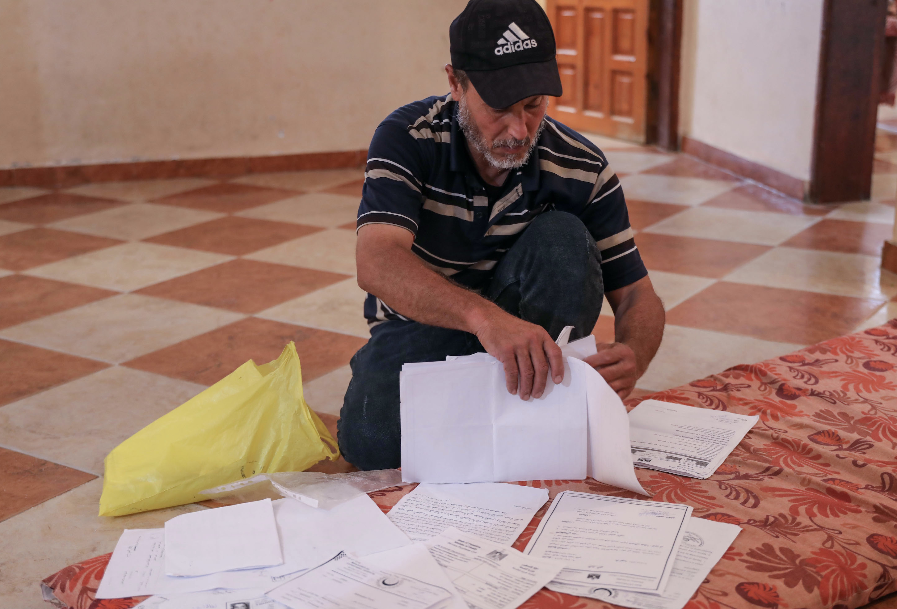Ashraf goes through endless paperwork in an attempt to get treatment for his son, Nidal 