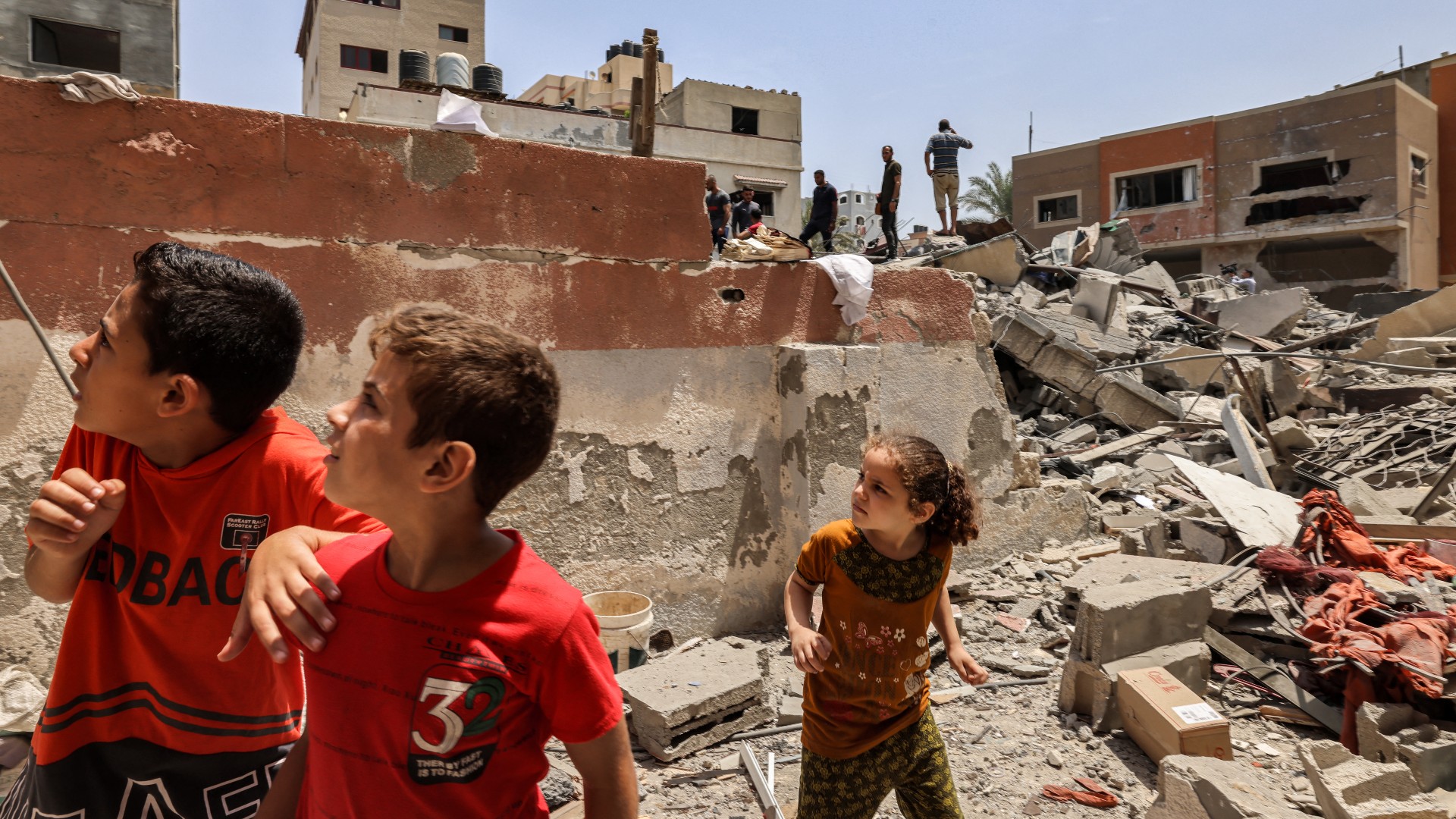 Children react following an Israeli air strike in Gaza City on August 6, 2022.
