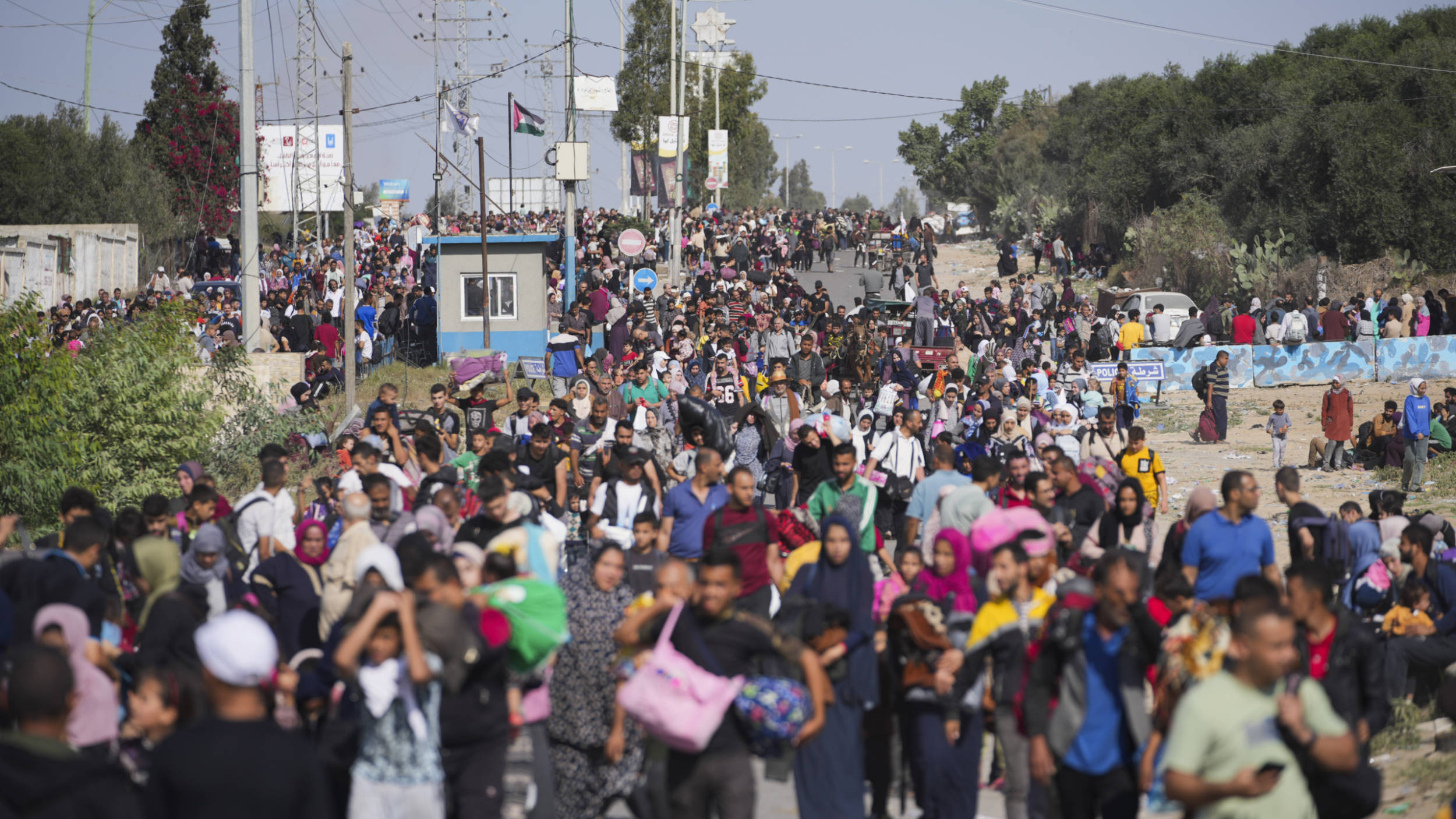 Palestinians flee to the southern Gaza Strip on Salah al-Din Street in Bureij, Gaza Strip, 10 November 2023 (AP)