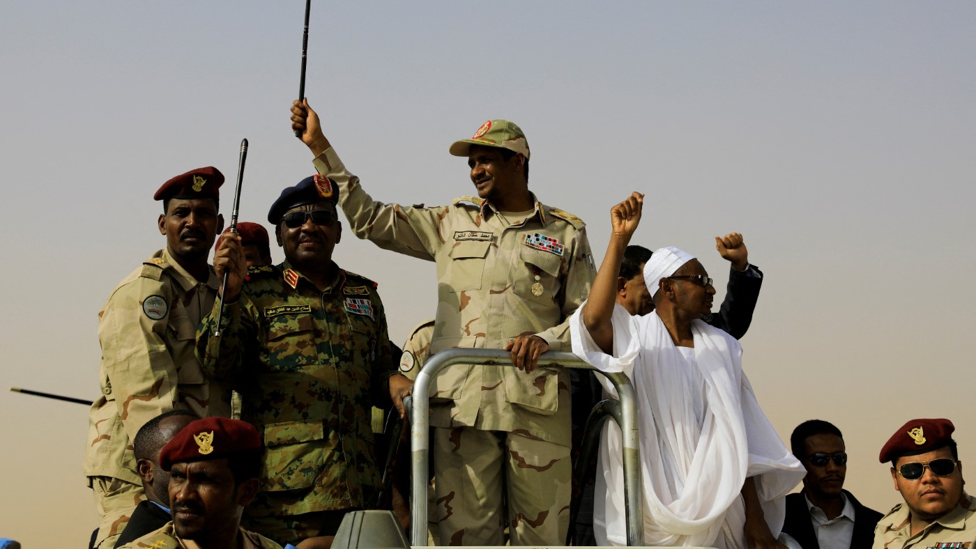 Lieutenant General Mohamed Hamdan Daglo greets his supporters as he arrives at a meeting in Aprag village, in 2019 (Reuters) 