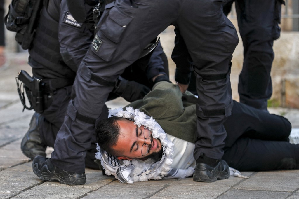 Israeli security forces detain a Palestinian man during a demonstration outside the Damascus Gate of the Old City of Jerusalem, 1 March 2022 (AFP)