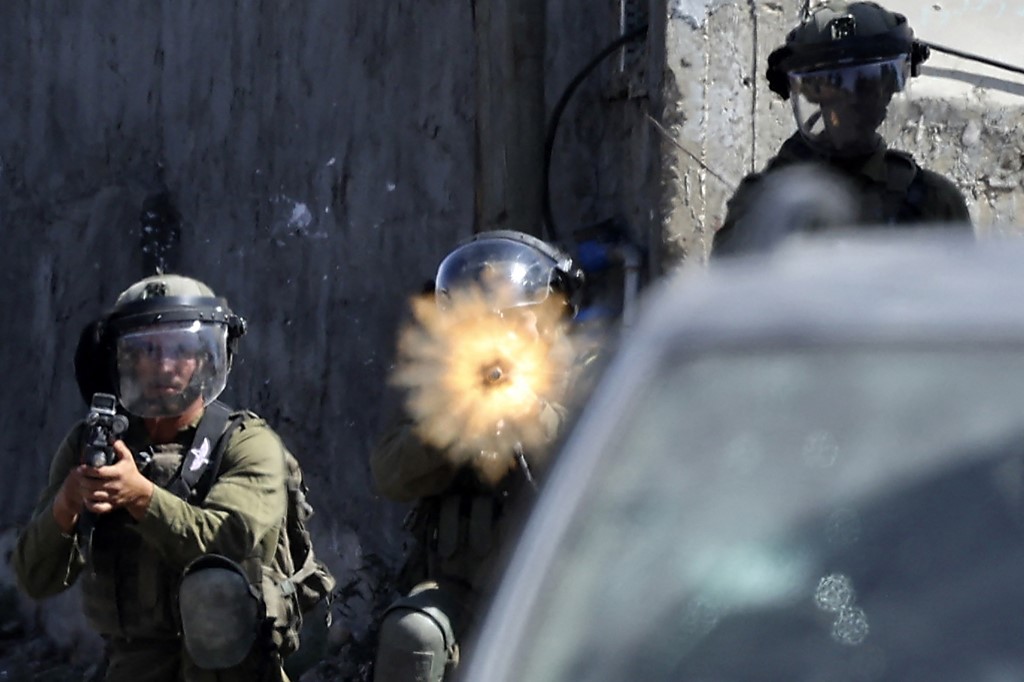 Israeli soldiers during clashes with Palestinian demonstrators in the village of Kfar Qaddum in the occupied West Bank, near the Jewish settlement of Kedumi, on 30 September 2022 (AFP)