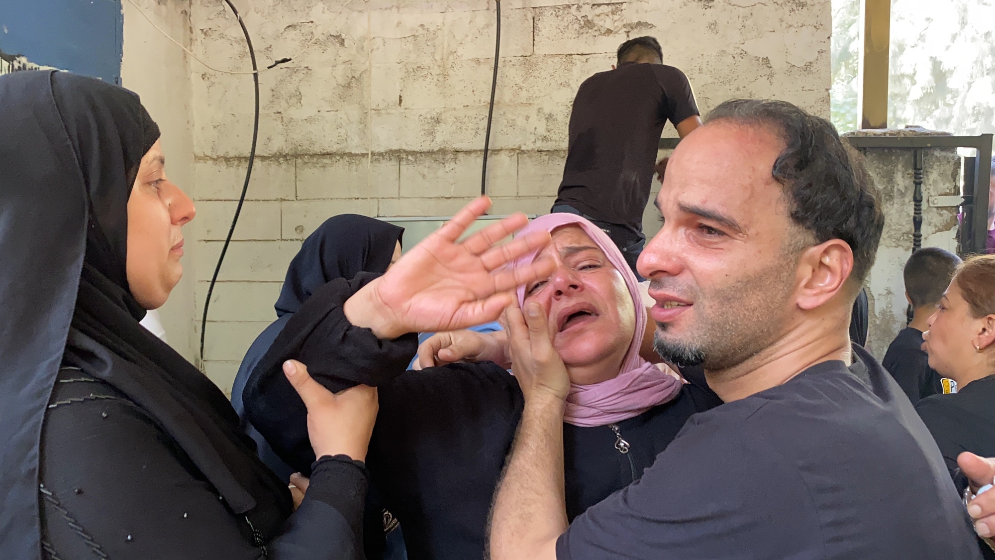 Relatives mourn during the funeral of Raed Abu Saif, 21, and Saleh Omar, 19, in Jenin refugee camp in the northern occupied West Bank on 16 August 2021 (MEE/Shatha Hanaysha)