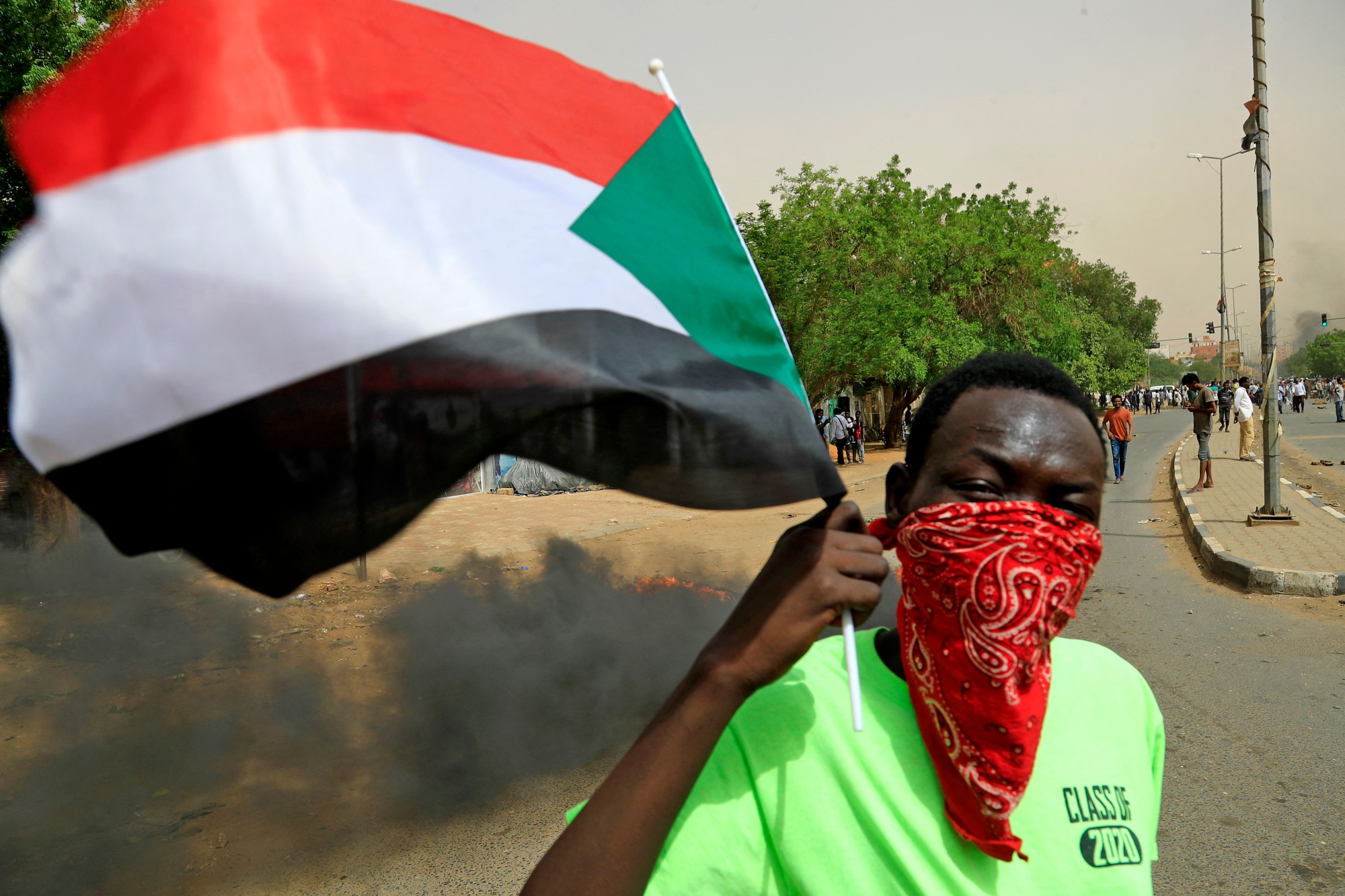 A protester waves a Sudanese flag during a demonstration in the capital Khartoum on 30 June 2021 (AFP)