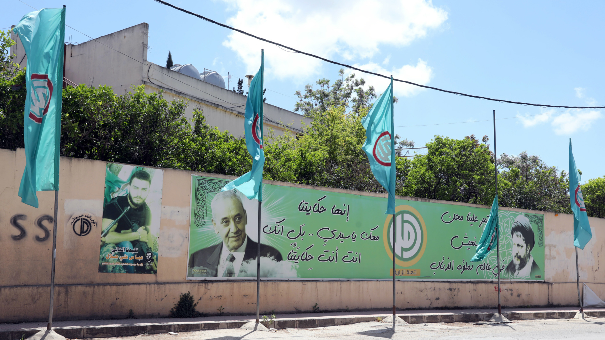 In Nabatieh, flagpoles stand heavy with Amal banners, and the face of Nabih Berri is brandished over almost every wall (MEE/Hasan Shaaban)