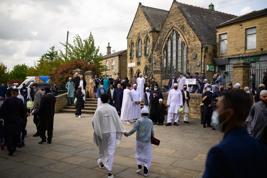 Muslims leave after the Eid al-Fitr prayer, which marks the end of the holy month of Ramadan, at Bradford Central Mosque, northern England, 13 May 2021 (AFP)