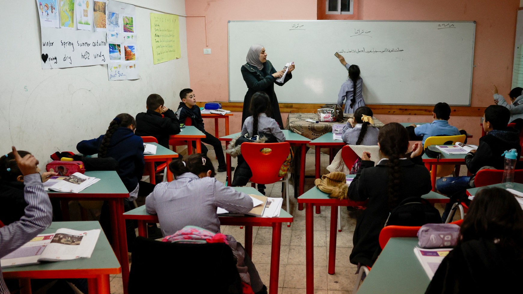 Palestinian girls learn Arabic at the UNRWA Jerusalem Girls' School in the Silwan neighbourhood of East Jerusalem, January 30, 2024 (reuters)