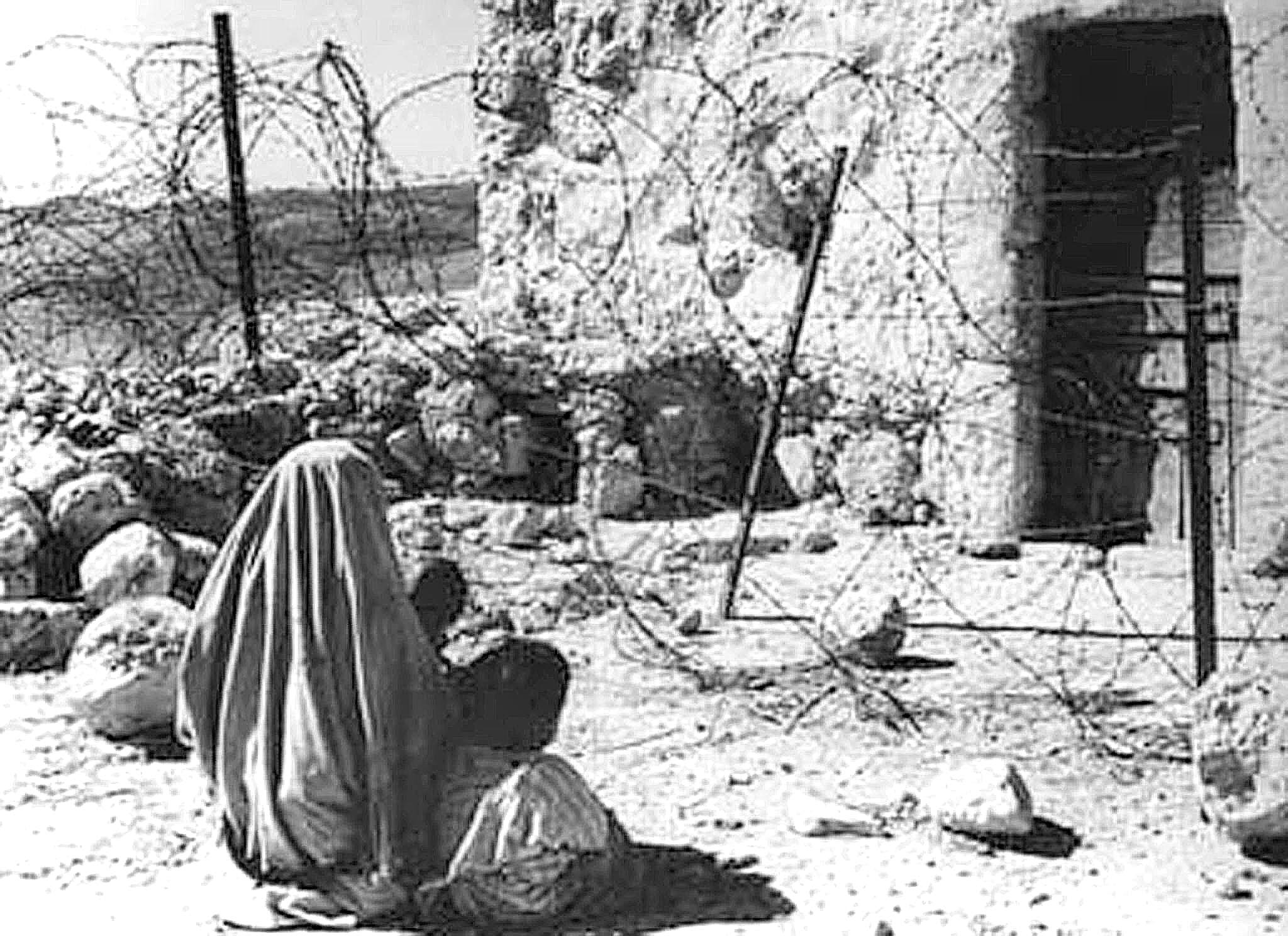  a Palestinian woman refugee and her child separated from their home by the "green line" after the 1948 war