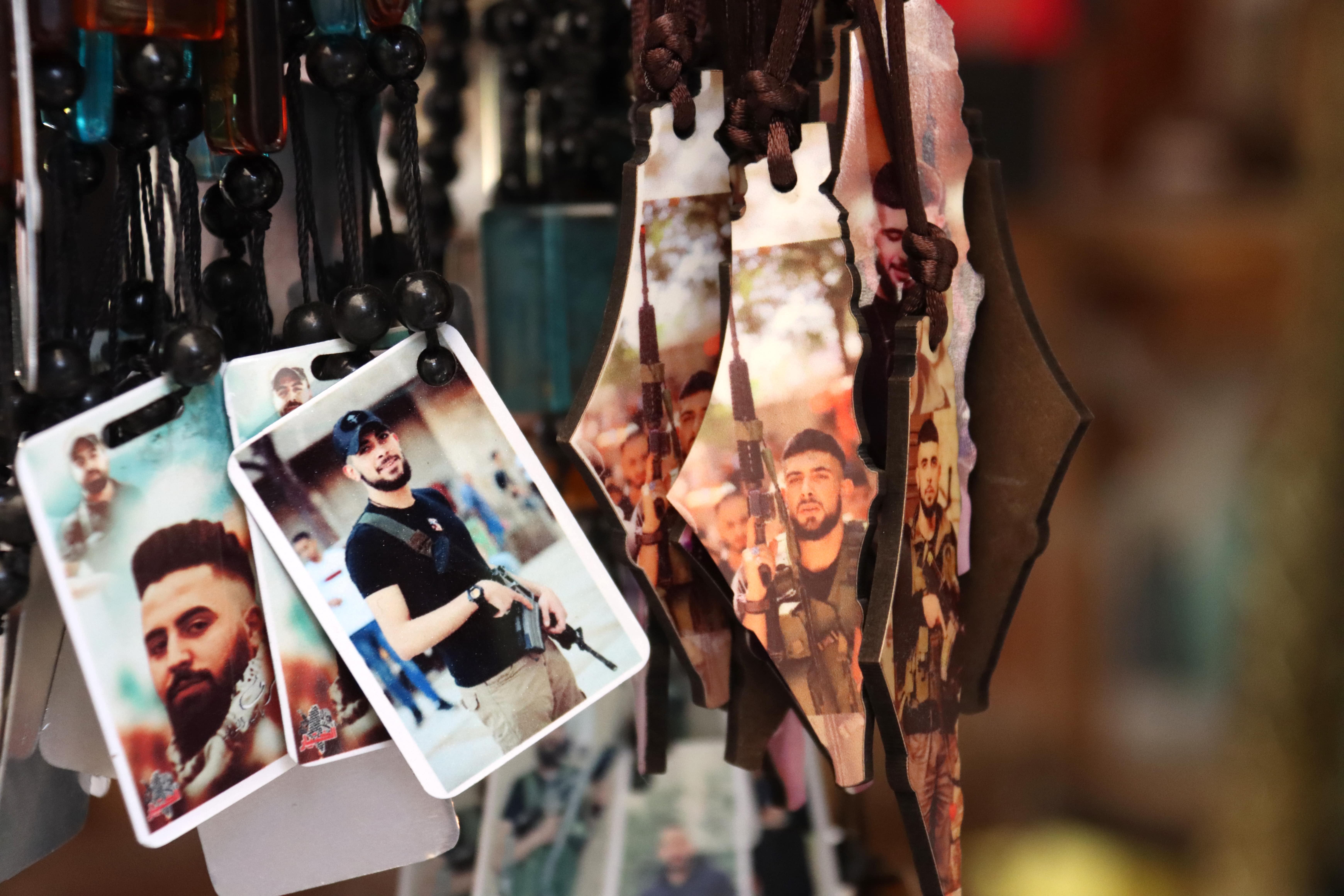Necklaces depicting photos of Nablus’ local fighters are shown at a souvenir shop in the old town of Nablus in the occupied West Bank on 24 October 2022 (MEE/Ahmad Al-Bazz)