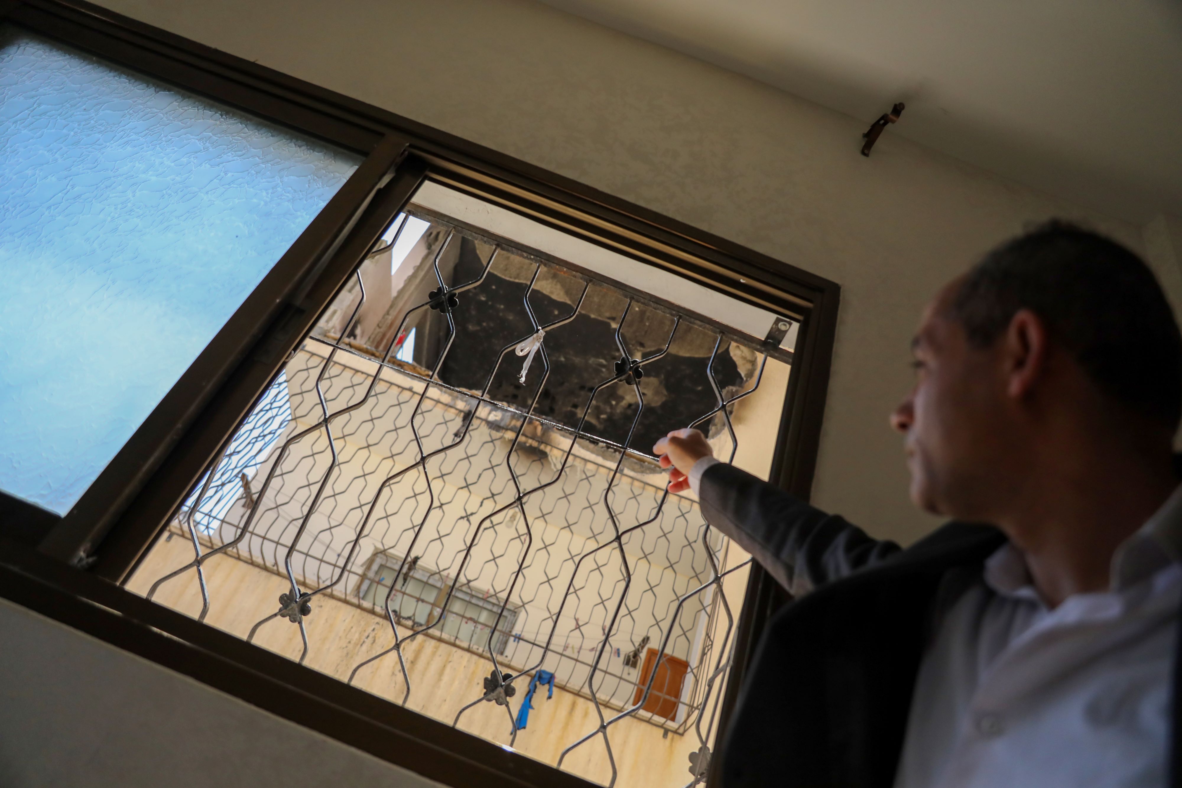 Riyad looks at the result of his bombed flat (MEE/Mohammad al-Hajjar)