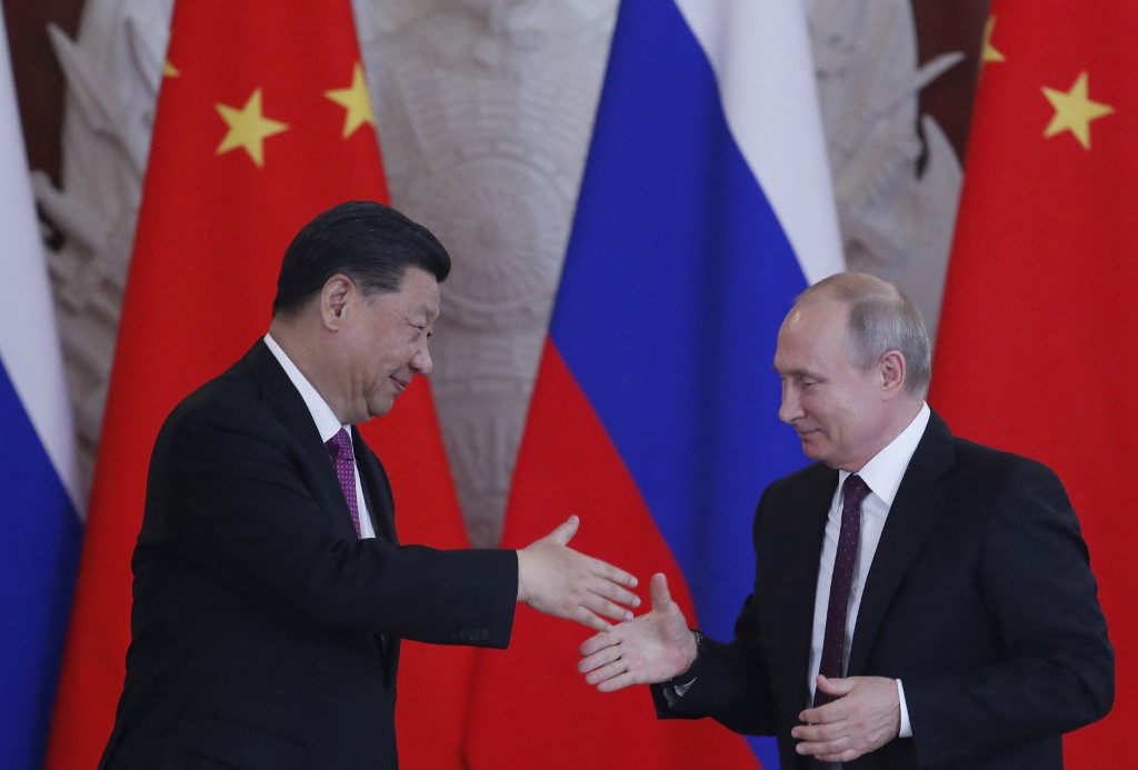 Russian President Vladimir Putin and his Chinese counterpart Xi Jinping shake hands following talks at the Kremlin in Moscow on 5 June 2019 (AFP)