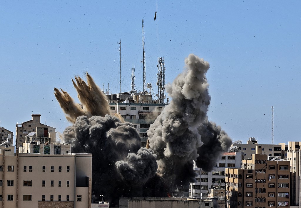 Smoke billows as an air bomb is dropped on the Jala Tower during an Israeli airstrike in Gaza city controlled by the Palestinian Hamas movement, on May 15, 2021 (AFP)