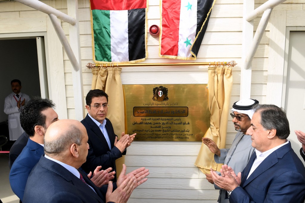 Syrian Minister of Health Hassan al-Ghabbash (L) and Emirati charge d'affaires Abdul Hakim al-Noaimi at the opening of a UAE-funded field hospital in Syria's Aleppo, on 21 November 2022 (AFP)