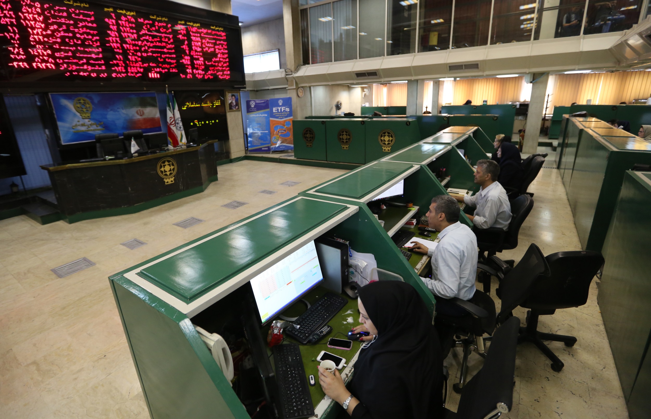 Iranian traders work at the Tehran Stock Exchange on 1 July 2019 (AFP)