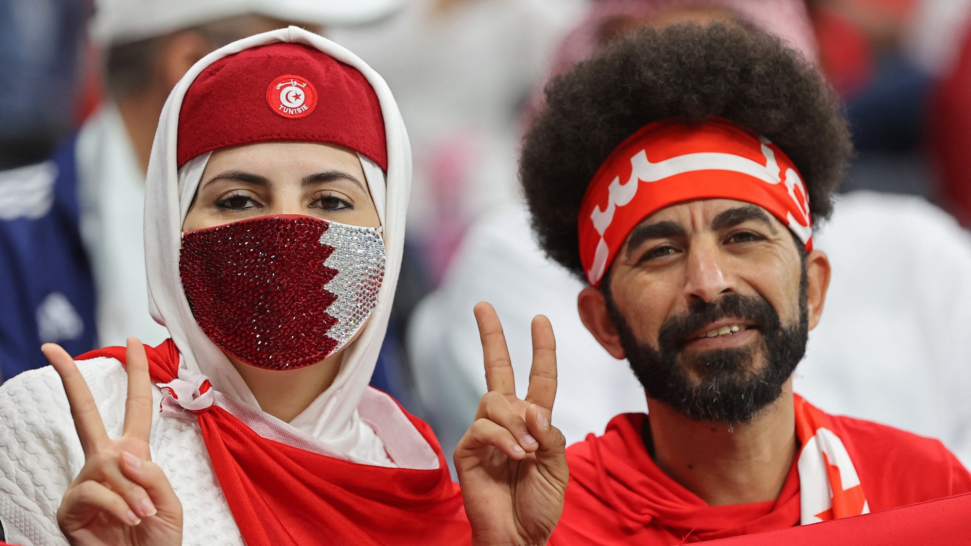 unisia supporters pose for a picture ahead of the FIFA Arab Cup 2021 final football match between Tunisia and Algeria at the Al-Bayt stadium in the Qatari city of Al-Khor on December 18, 2021.