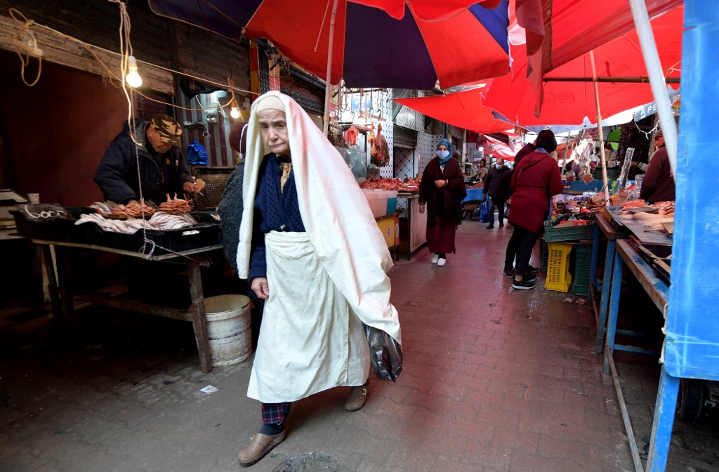 Tunisians shop at Halfaouine market near central Tunis on 15 February 2022 (AFP)