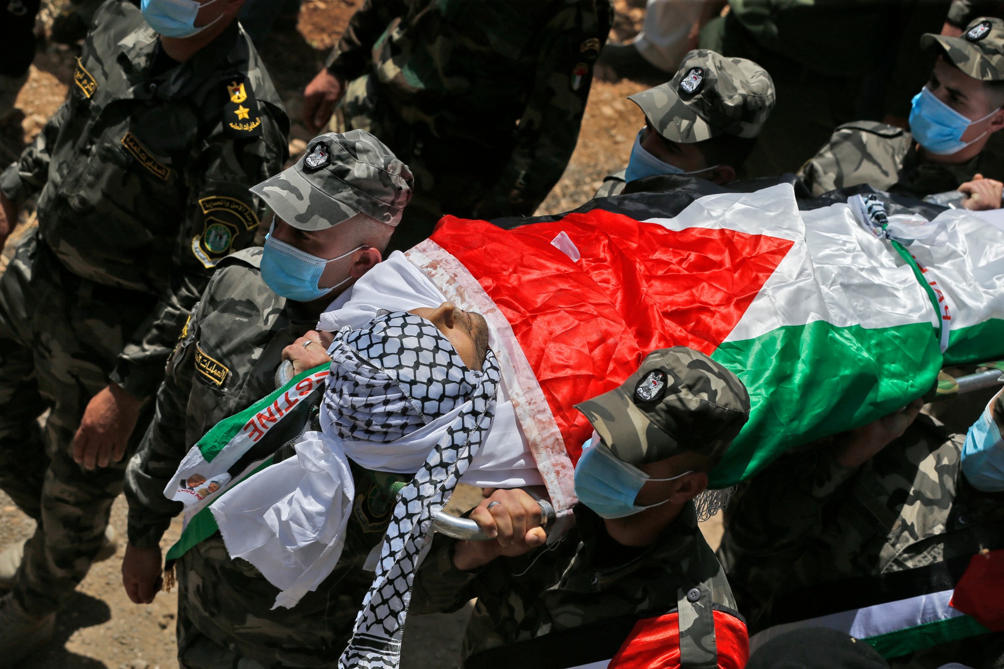 Palestinian special operations officers carry the body of Ahmed Daraghmeh, 30, who was killed by Israeli forces the previous day, during his funeral in the northern West Bank on 12 May 2021 (AFP)