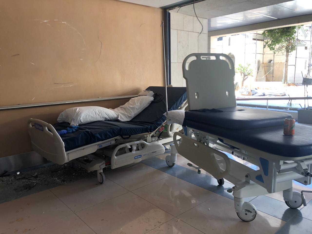 Hospital beds next to a blown-out window in St George hospital (MEE/Jonathan Dagher)