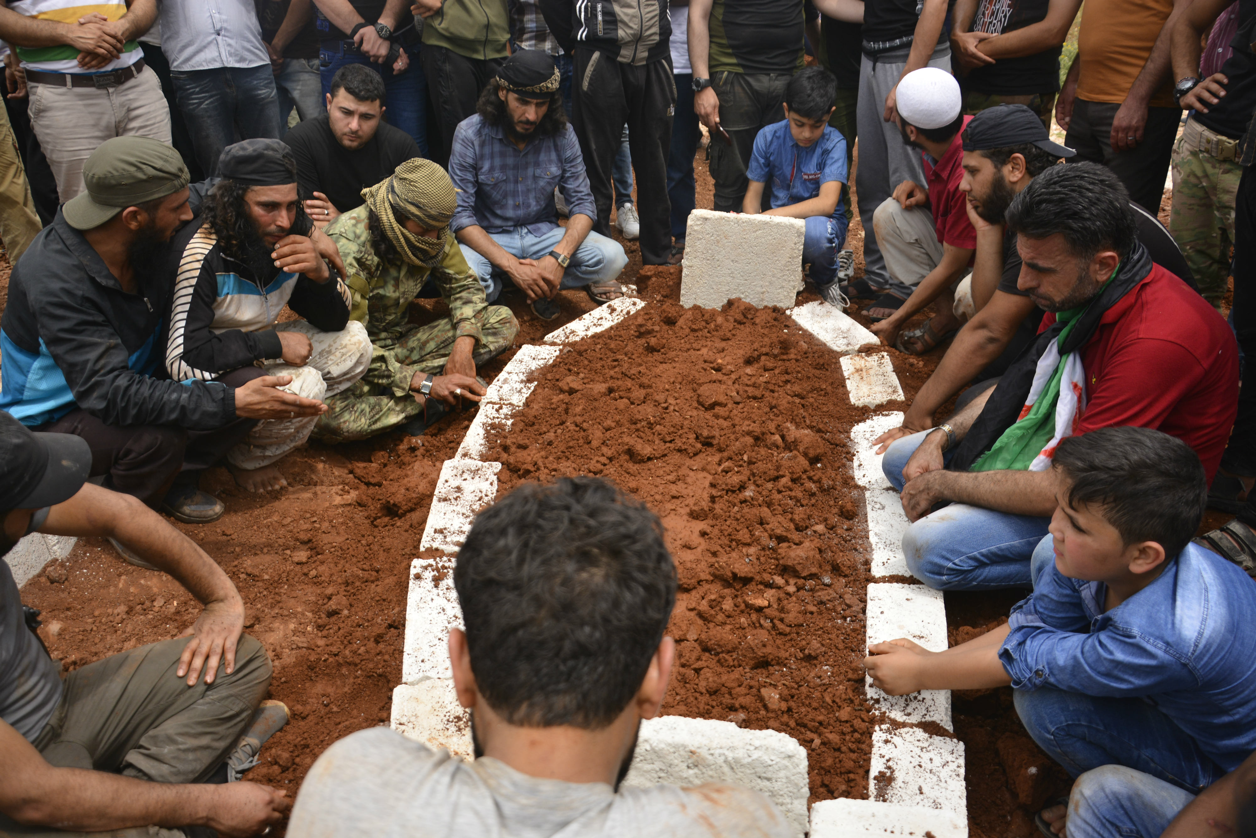 Syrians mourn at the grave of Abd al-Basset al-Sarout, in Idlib province's al-Dana (MEE/Harun al-Aswad)