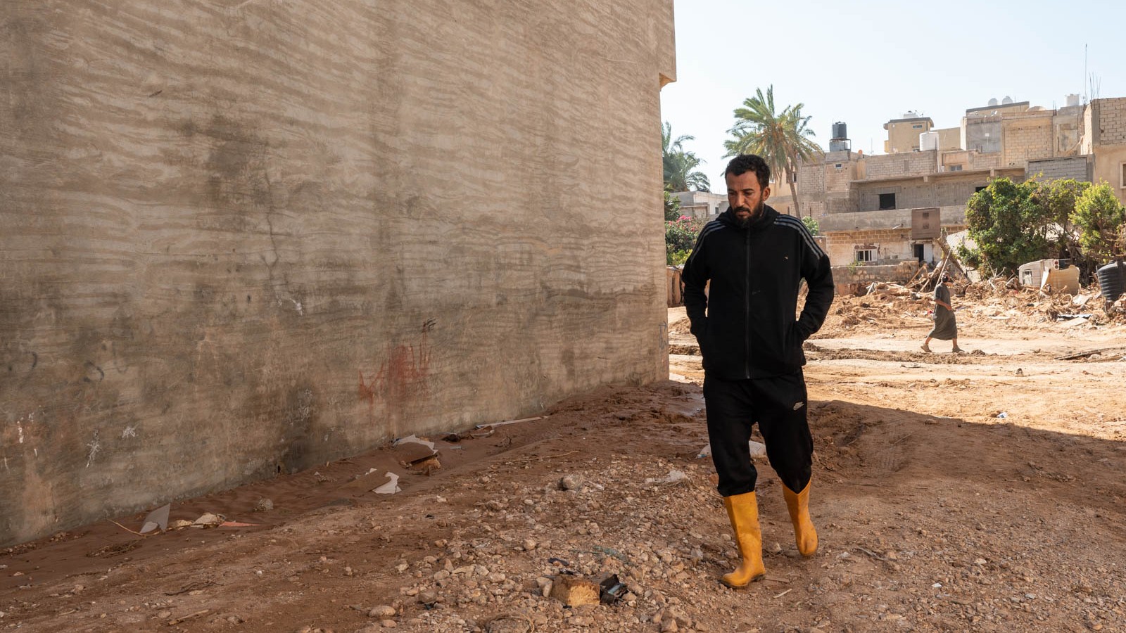 A survivor walks through a destroyed part of Derna (MEE/Taha Jawashi)