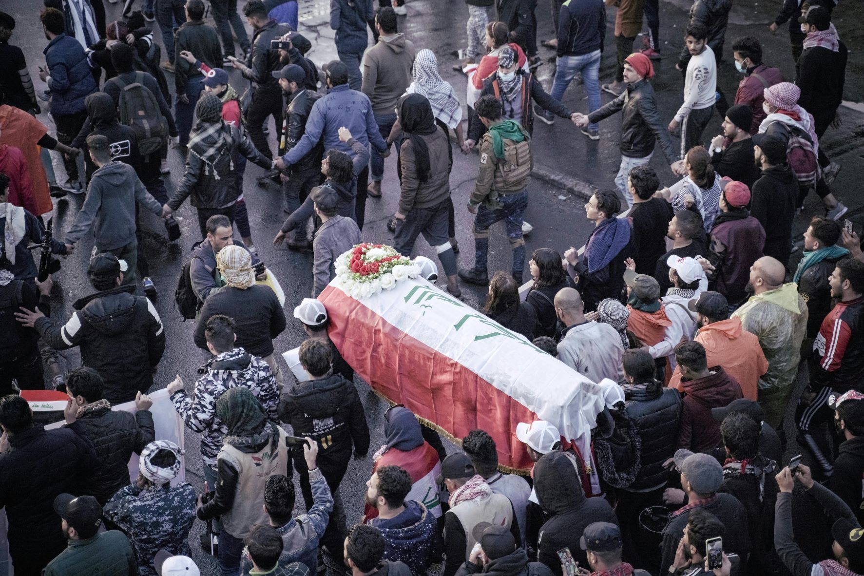 Mourners carry the coffin of Yussef Sattar, a local journalist who was reportedly killed while covering anti-government demonstrations, during his funeral in the capital Baghdad in January 2020 (AFP)