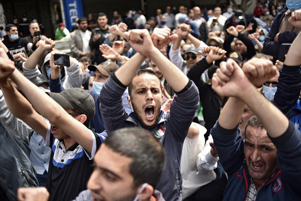 Algerians shout slogans during an anti-government demonstration in the capital Algiers on April 30, 2021