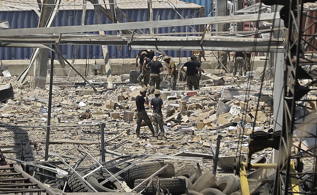 Rescuers search through debris on 5 August after the explosion at Beirut’s port (AFP)