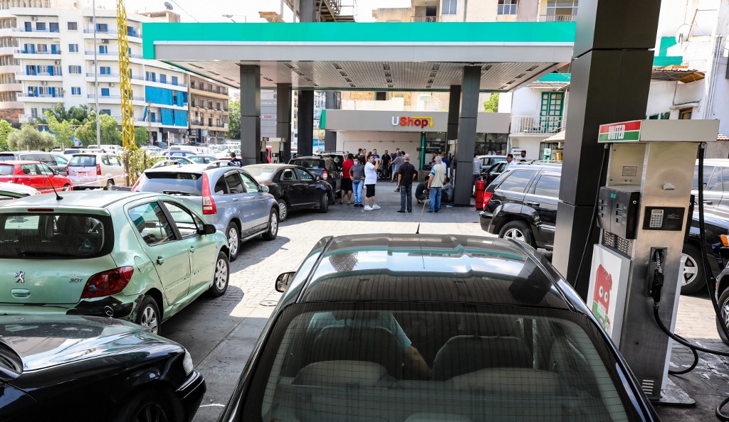 Drivers queue in front of a petrol station in Beirut on 13 August 2021 (AFP)