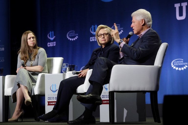 Hillary and Bill Clinton, and their daughter Chelsea, speak in Chicago on 16 October (AFP)