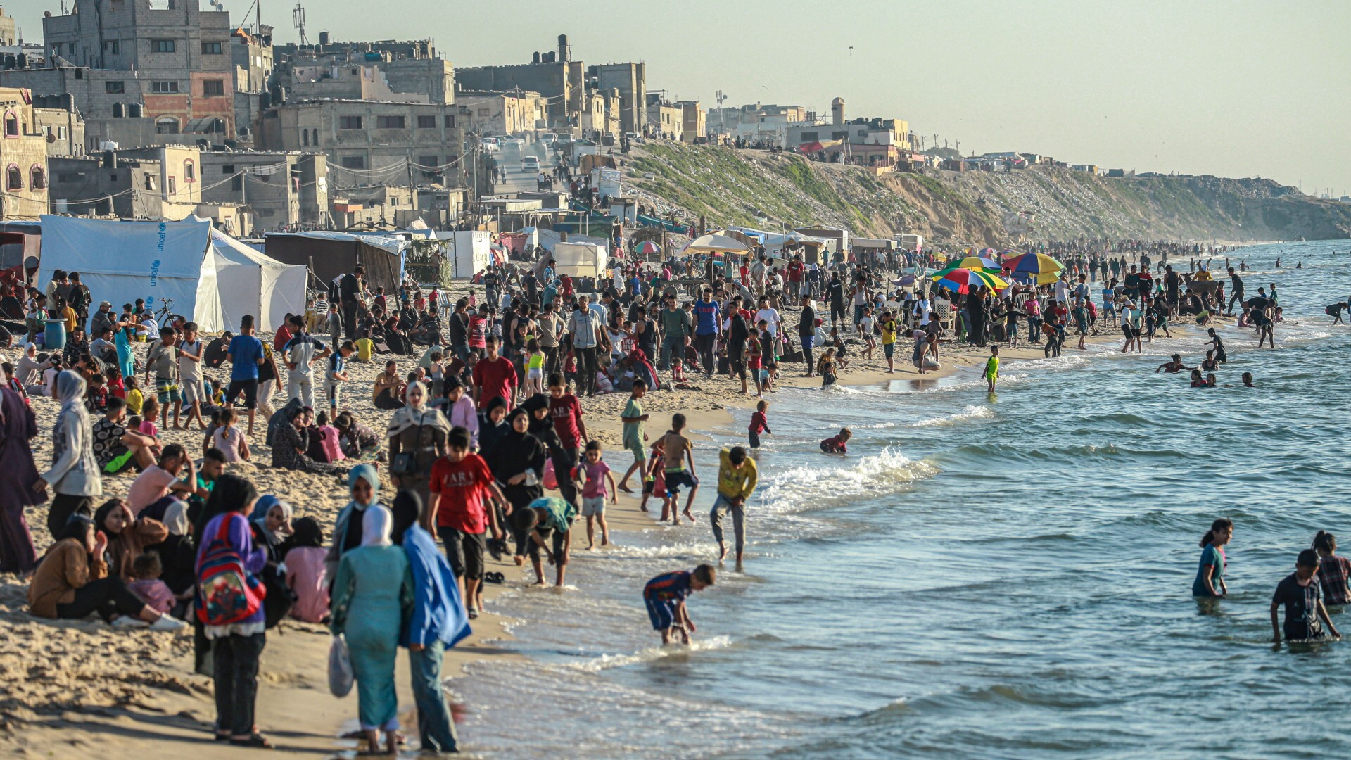Palestinians gather on the beach in Deir el-Balah in the central Gaza Strip on 17 April 2024 (AFP)