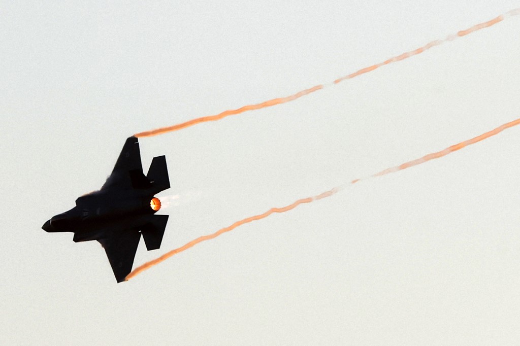 An F-35 Lightning II fighter jet performs at a ceremony in Israel’s Negev desert on 24 June 2021 (AFP)