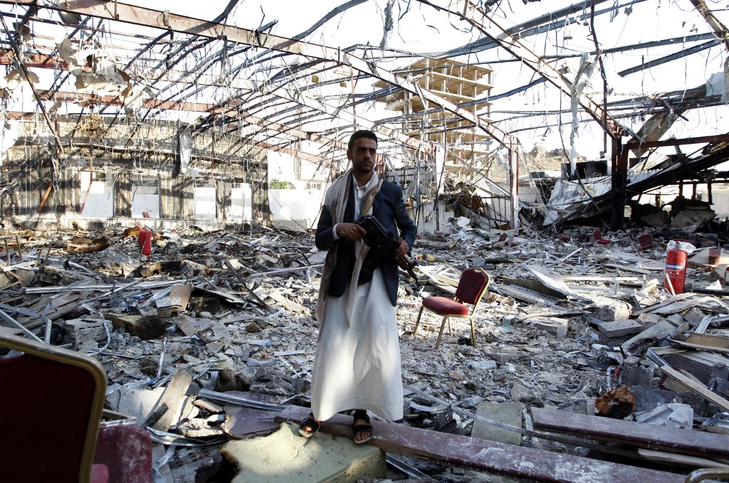 A Yemeni man stands where the Al-Kubra hall, bombed by the Saudi-led coalition in October 2016, once stood (AFP) 