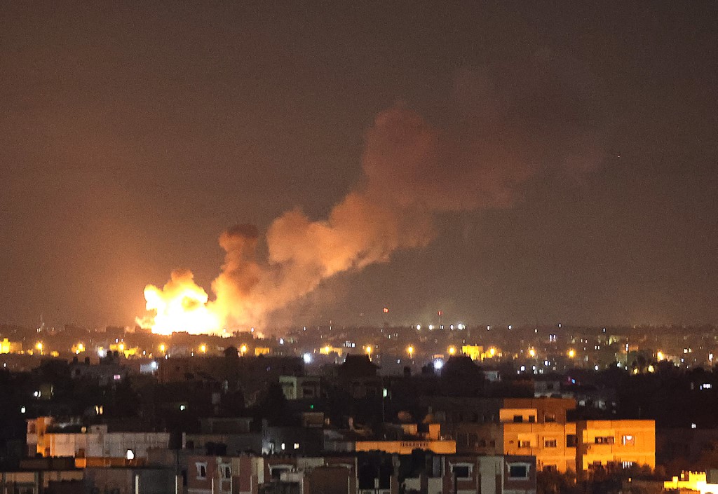 Flames rise after an Israeli air strike on the Gaza Strip on 11 May 2021 (AFP)