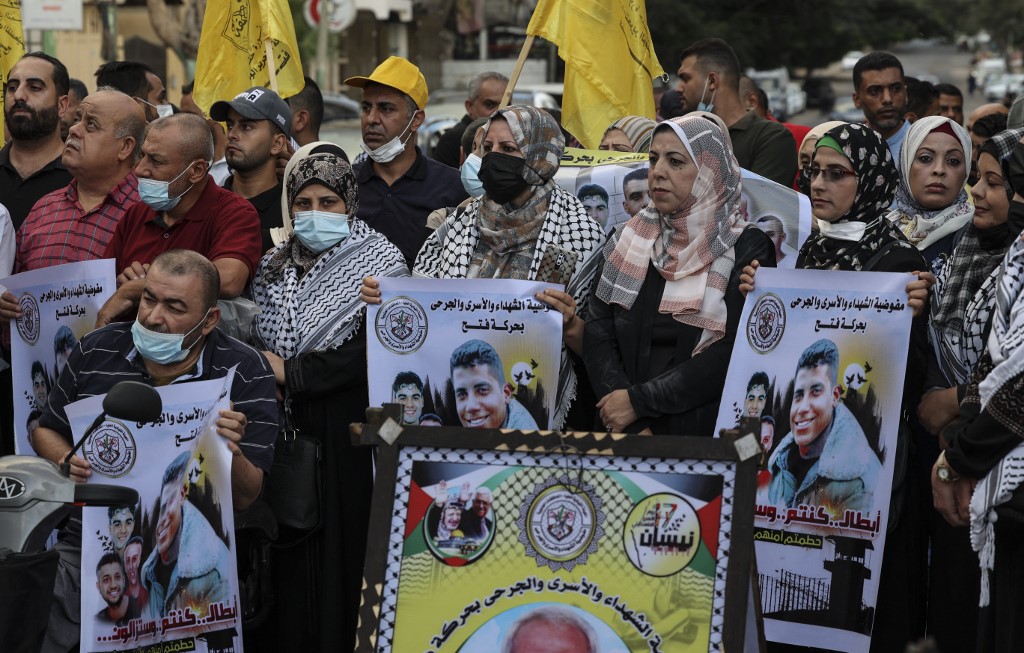 Demonstrators express support for the six Palestinian prisoners who escaped from Israel’s Gilboa prison on 11 September 2021 in Gaza City (AFP)