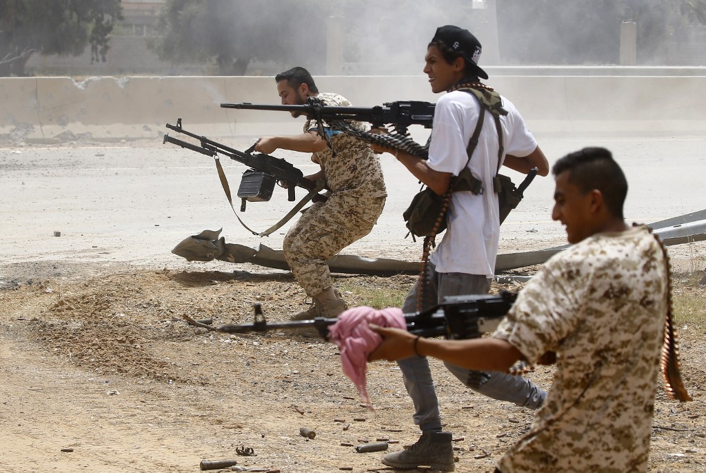 Fighters loyal to Libya’s UN-backed government open fire near Tripoli on 13 June (AFP)